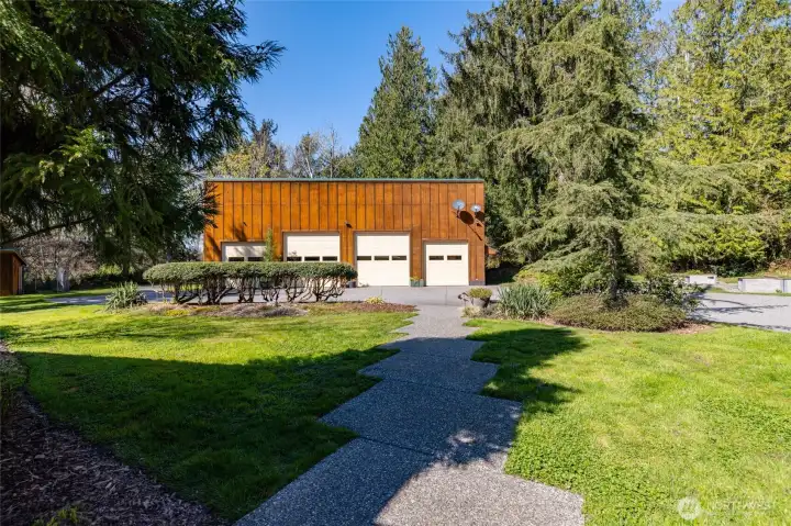 The 60x30 finished shop sits just across the paved drive/parking apron.  The shop has two 10-ft and two 12-ft overhead doors, 220 power, and a full bathroom.  Dream hobby shop, or perfect for your toys.