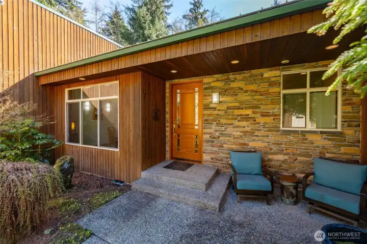 Custom door, soffit lighting, and a cool respite from the sunny back patio.