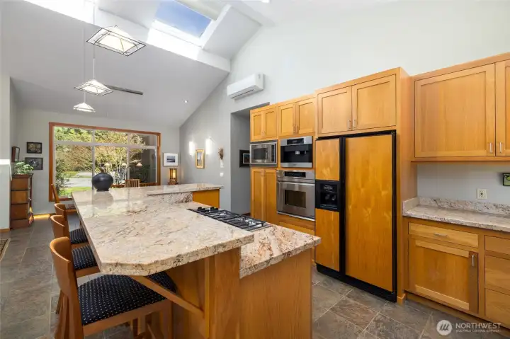 This kitchen is truly the heart of the home.  Beautiful wood cabinets and granite counters anchor the central island.  Premium appliances include Thermador cooktop, Dacor wall oven, Miele built-in coffee maker.