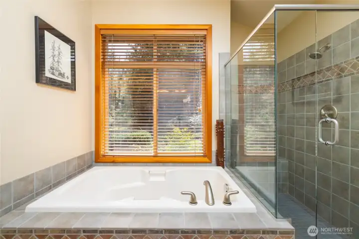 Primary suite #1 bath - soaking tub plus an oversized tiled shower w/bench. Heated tile floors.