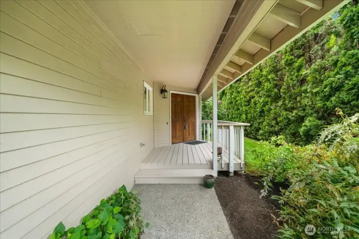 Walking towards the front door is a fully covered walkway and porch.