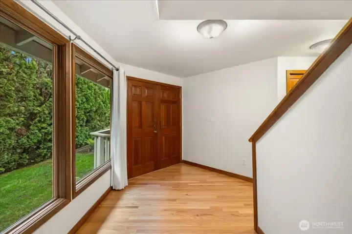 As you enter this wonderful home you are greeted with gorgeous hardwood floors and large new wood wrapped windows.