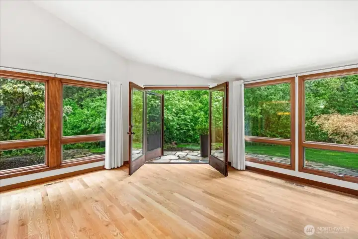 These french doors bring you out to the paver patio which wraps around from the side to the backyard.
