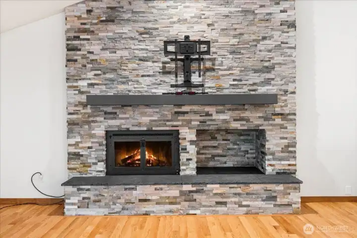 This is a new gas fireplace with beautiful tile and gorgeous veneer stone.
