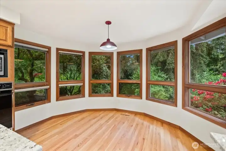 This is the kitchen eating area with those gorgeous wood wrapped windows.  The views from these windows are private, peaceful and lush with beautiful landscaping.