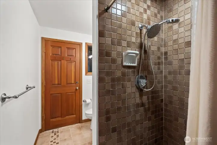 Main floor 3/4 bath with door out to the side yard.