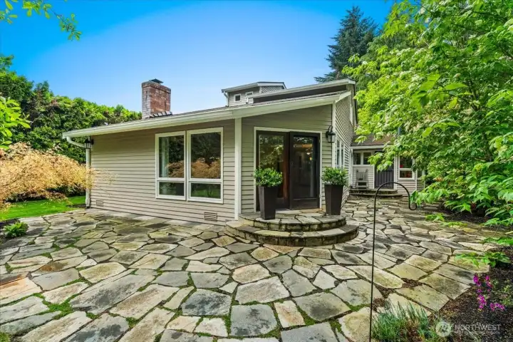 Step into the beautiful backyard retreat, where lush landscaping and elegant paver details create a stunning architectural setting perfect for relaxing or entertaining.