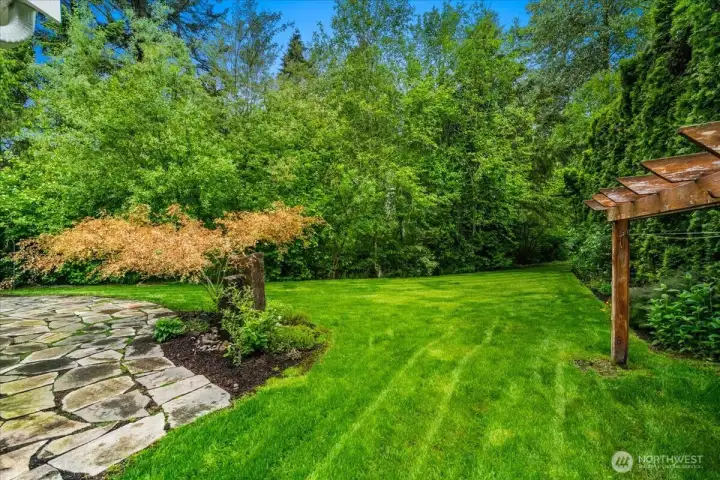 There is a lovely water feature just to the right of the patio pavers.  It's a tall stone that bubbles out the top with water.