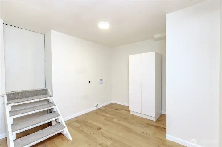 Downstairs laundry area + huge storage area up the stairs.