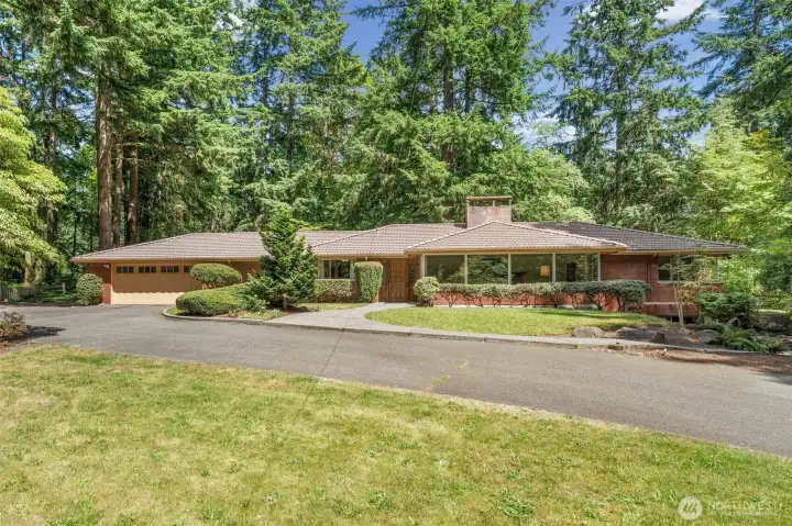 A rare "Top of Pike's Peak" opportunity on 1.745 private acres, this Bellevue property offers an estate-like setting surrounded by mature evergreens, a gracious circular drive, and exceptional potential to create your dream equestrian retreat.