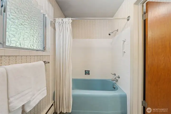 The full bathroom includes a tub and shower combination with a privacy window that welcomes natural light while maintaining seclusion. A functional layout and timeless design provide an excellent foundation to enjoy today or personalize over time.