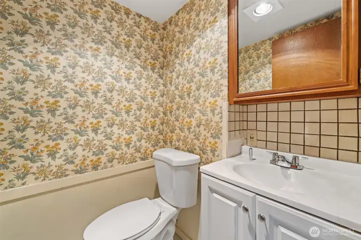 Conveniently located next to the lower-level kitchen, this half bath adds everyday convenience for guests and entertaining. Its central location makes it an ideal addition to the home's flexible lower-level living space.