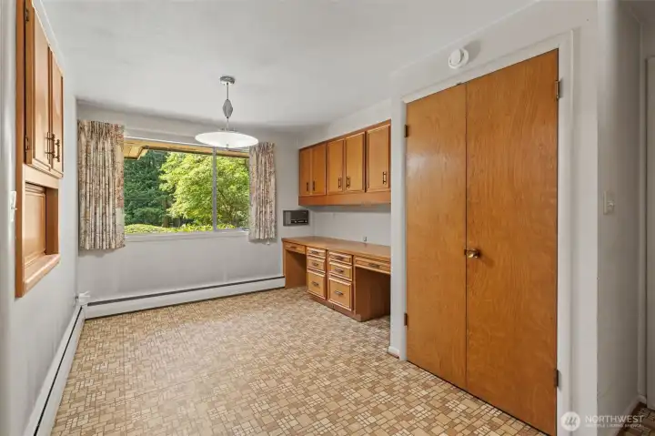 Located between the upstairs kitchen and garage, this versatile bonus space offers built-in cabinetry, a desk area, and additional storage for everyday organization. Whether used as a mudroom, craft room, homework station, home office, or drop zone, this flexible space easily adapts to your lifestyle.