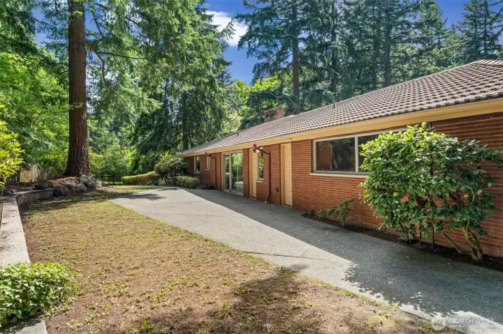 The upper level backyard features multiple exterior access doors, making it easy to enjoy indoor-outdoor living and providing convenient access to different areas of the home. The spacious patio is right off the dining room. A  peaceful setting creates the perfect place to relax or entertain.