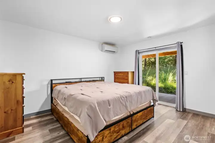Primary bedroom with individual mini split, sliding glass door steps out to your own private covered patio Primary bedroom with individual mini split, sliding glass door steps out to your own private covered patio