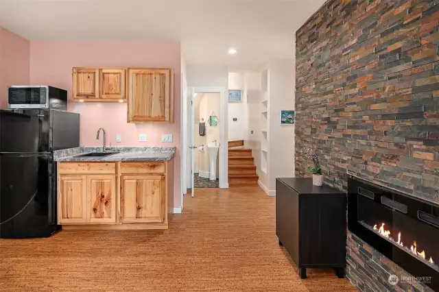 Living area has a small kitchenette (refrigerator, sink, and microwave). Tall ceilings. Steps on far wall are artistic, custom built koa wood for treads & risers with in-laid madrona end-grain rounds and indirect lighting...beautiful!!