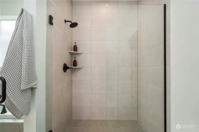 Fully tiled walk-in shower.