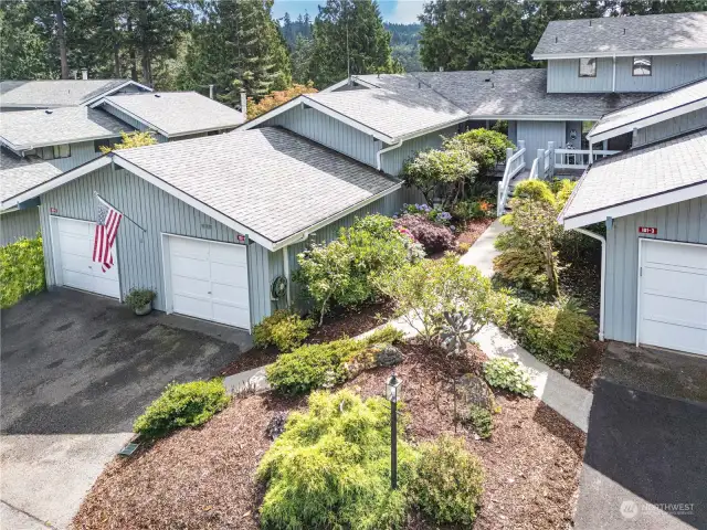 101-2 Highland Greens is the condo to the right of the flag. The one-car garage has a work bench & storage space.