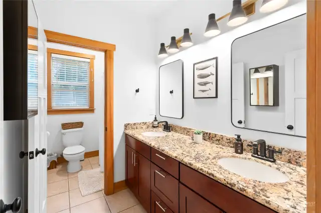 Shared bathroom has a double vanity and  private water closet.