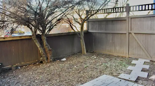 fully fenced yard with patio. yard is blank slate for you final touches