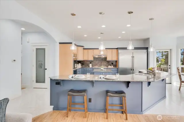 Bar wraps around 3 sides of the island; seating for everyone! Walk-in pantry on the left.