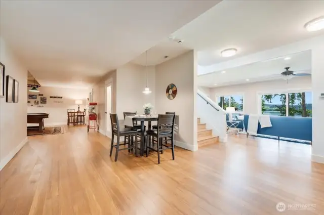 Wide view of LL space including rec room, wine cellar (between popcorn maker & nook table), and family room