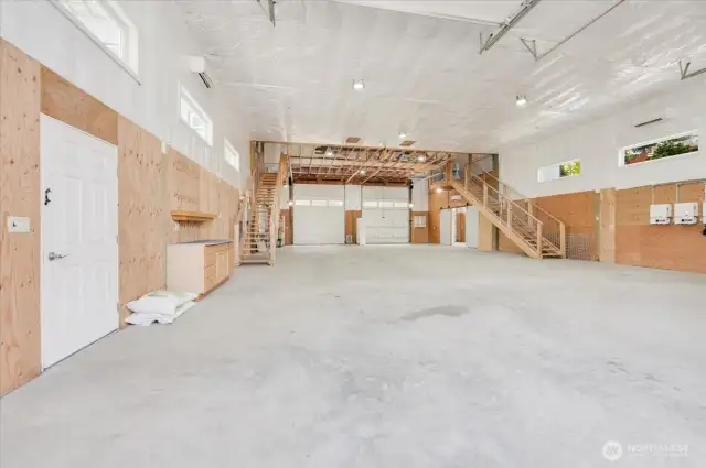 Enviable shop/garage features two 70ft drive-thru center bays with 12'X14' doors and no posts