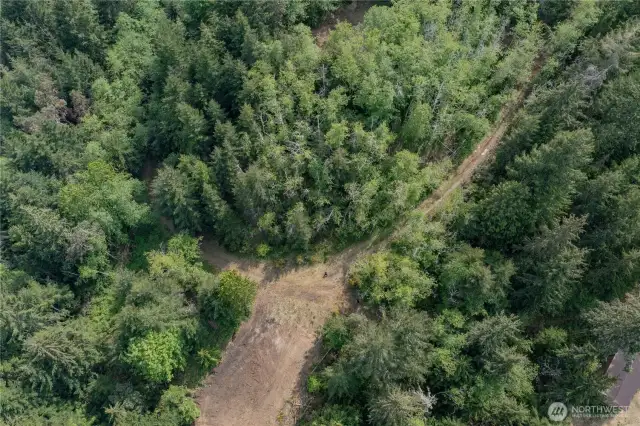 The large clearing in this aerial shot is the section of private land that the easement goes through to access the upper loop via Lot 11. The Hamma Ridge Well House is visible in the bottom right corner