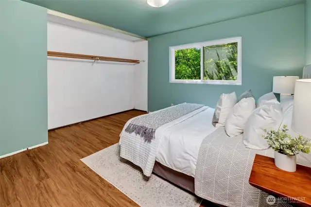 The large primary shares no common walls and has a half bath attached.
