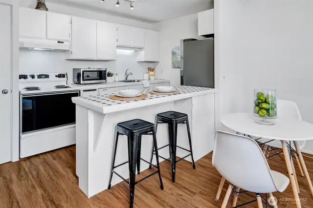 The open kitchen also has a breakfast bar for an easy meal or a place to sit and relax with a paper or book.