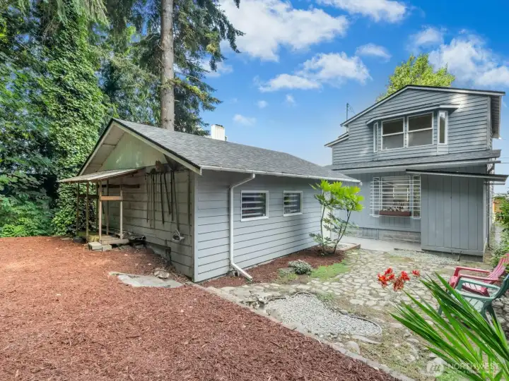 A good picture of the property from the rear. There is some unutilized space behind the garage. The detached garage is on the left of the photo and there is a small utility shed attached to the back of the home on the right of the photo