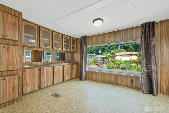 Bright dining space with built-in cabinetry and ample storage, perfect for gatherings.
