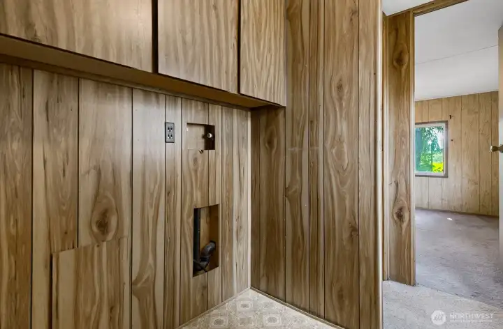 Dedicated laundry nook with hookups and storage cabinets, ready for your washer and dryer.