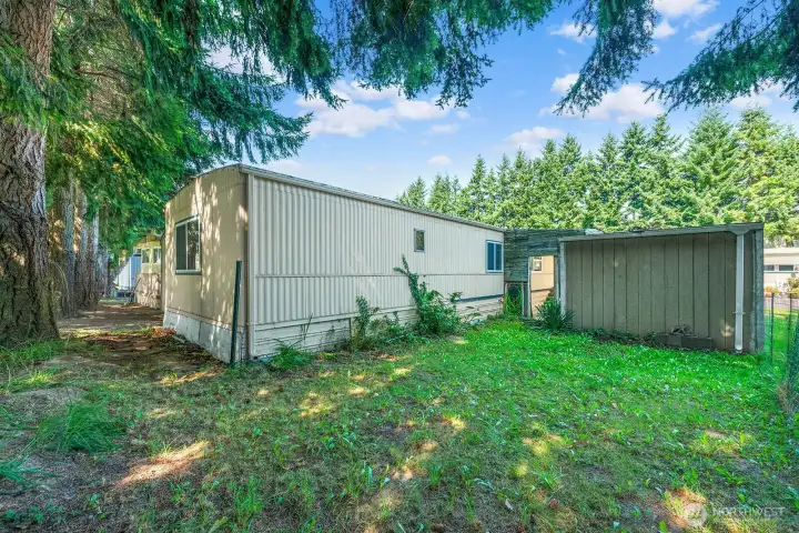 Spacious backyard with storage shed and room to create your own outdoor retreat.