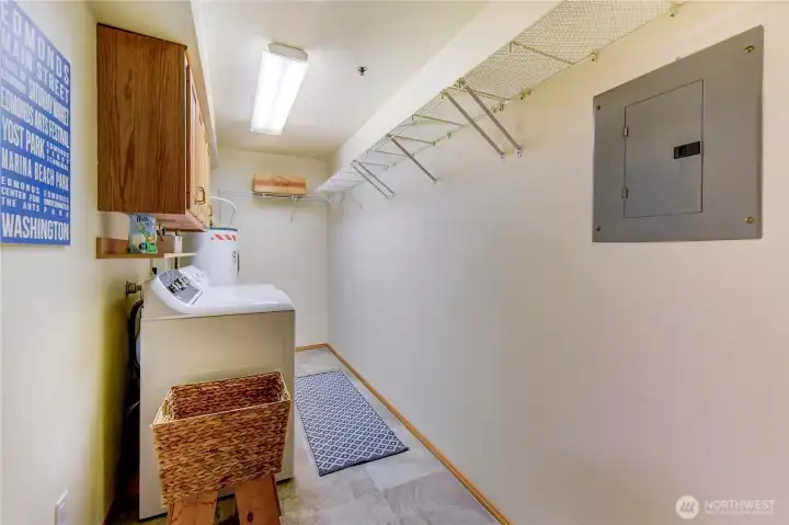 Utility room with side by side washer/dryer and storage