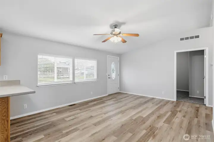 Enter into main living area.  Home has been freshly painted and new flooring throughout.  Move in ready.  Door straight ahead leads to one of two secondary bedrooms.