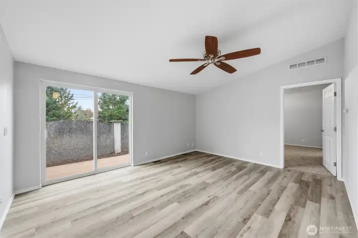 Family room off main living area. Sliding glass door to back deck area.  Door on right leads to primary bedroom.