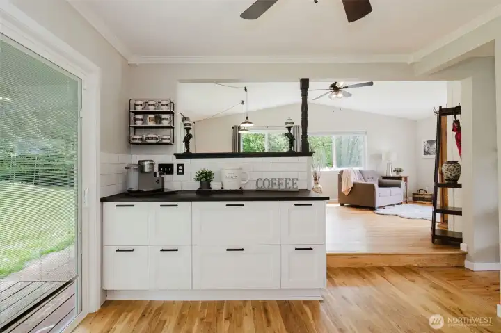 More kitchen storage/coffee bar. Slider leads out to the beautiful yard.