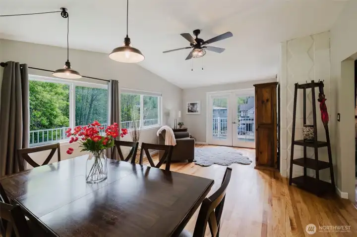 Dining room and extra sitting area with doors leading out to the deck and lake view.