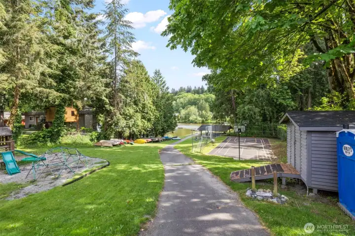Community park has a playground, kayak storage, sports court, beach area, gazebo and dock.