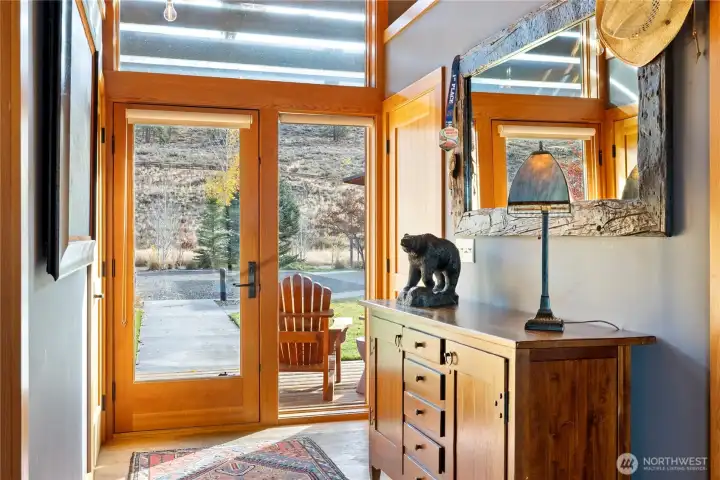 The light-filled main entry includes generous coat closets, hardwood floors and views to and from the home.