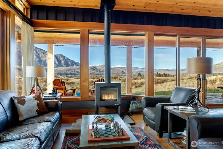 The warm wood interior, floor to ceiling windows and wood stove create a setting of unparalleled beauty and comfort.
