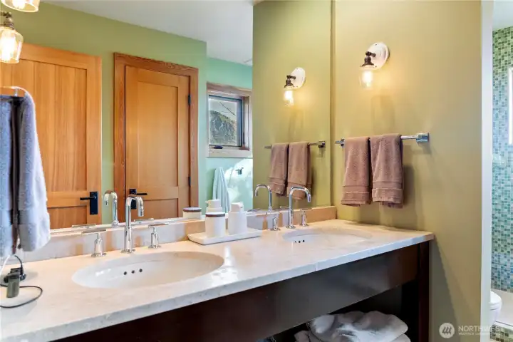 The primary bathroom has a double sink and high-quality fixtures.