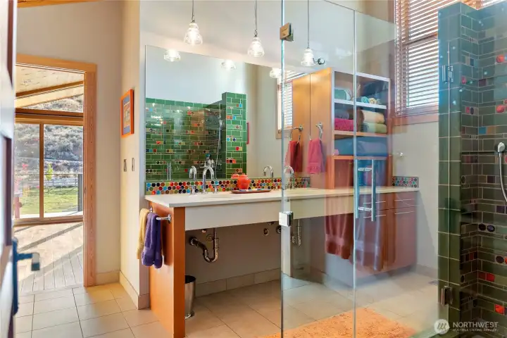 The bathroom has beautiful fixtures and exceptional custom tile work.