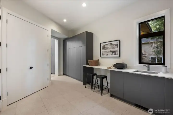 Large laundry/mudroom with sink and storage