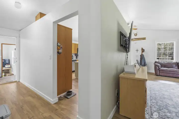 View from the hall to the bedrooms. Right is the living area, center is the entrance to the kitchen and hall to the left is the utility room and into the flex room