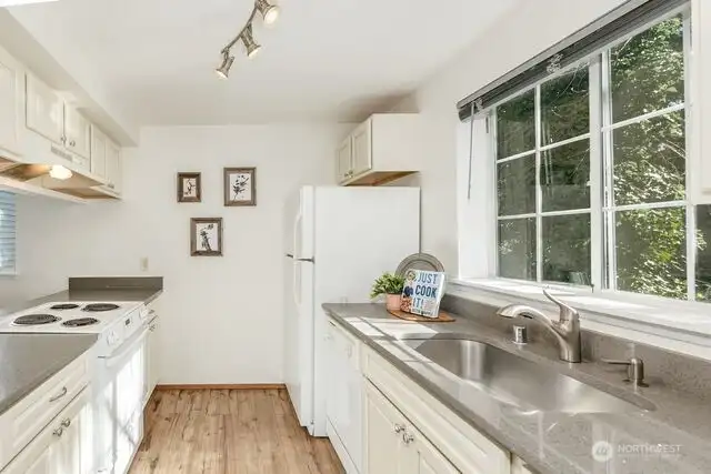 Kitchen with custom cabinet, and quartz countertops facing the back