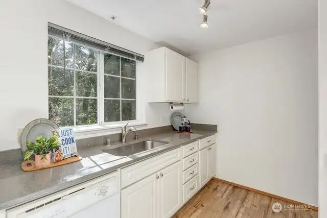 another view of the beautiful kitchen and private view of the back