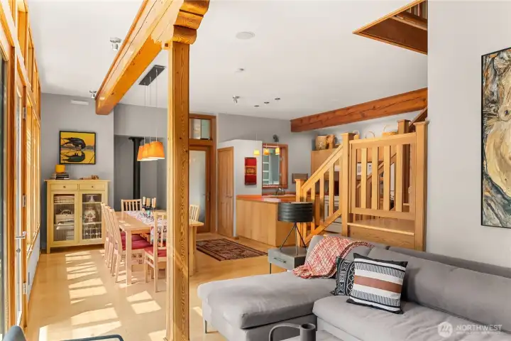 Carved tamarack columns and beams characterize the first floor interior and its open and cozy floorplan.