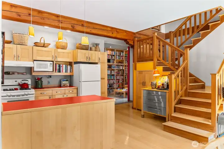 The open stairway artfully connects the main and kitchen and living spaces with the second story bedroom suite.